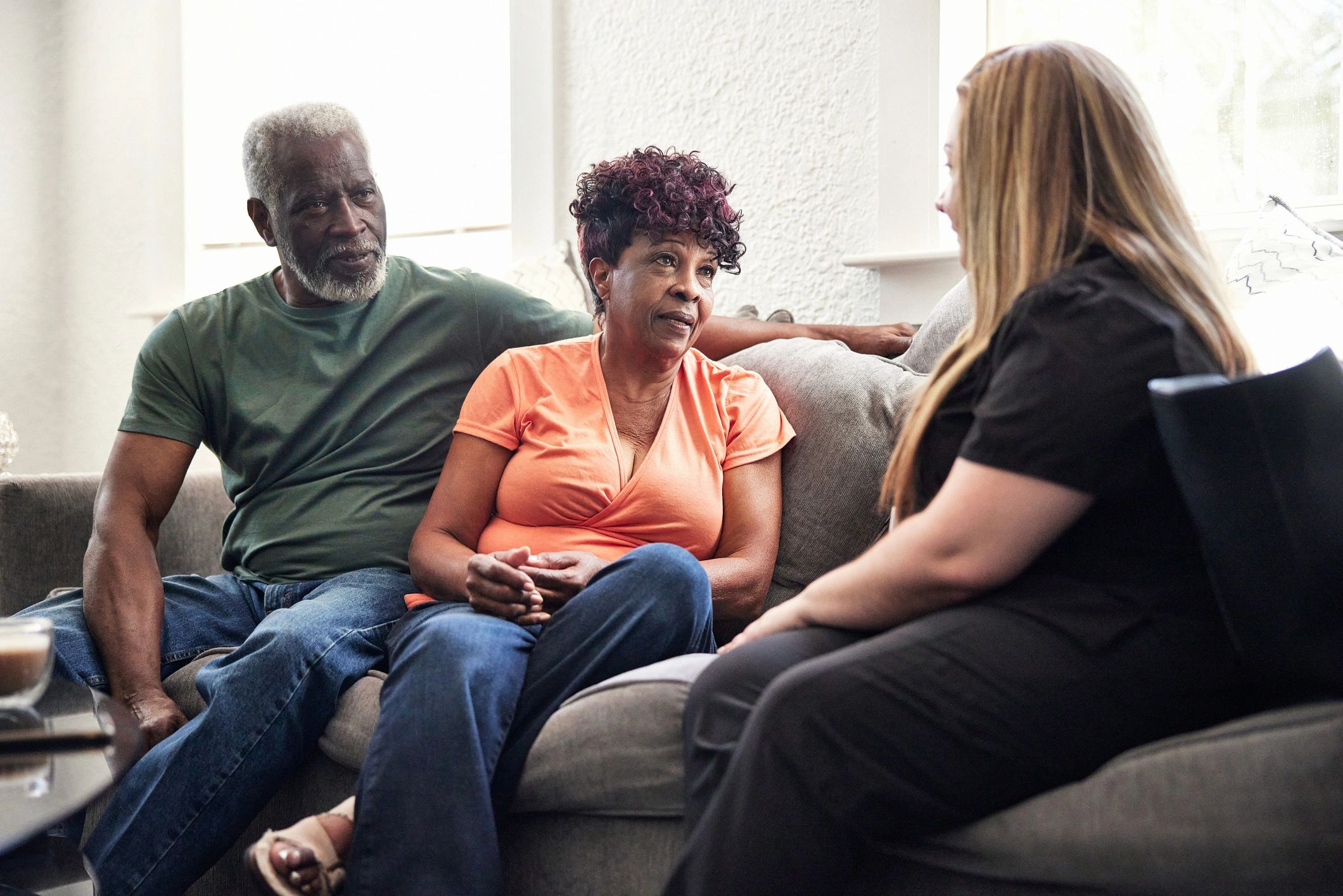 Caregiver talking with senior clients at home