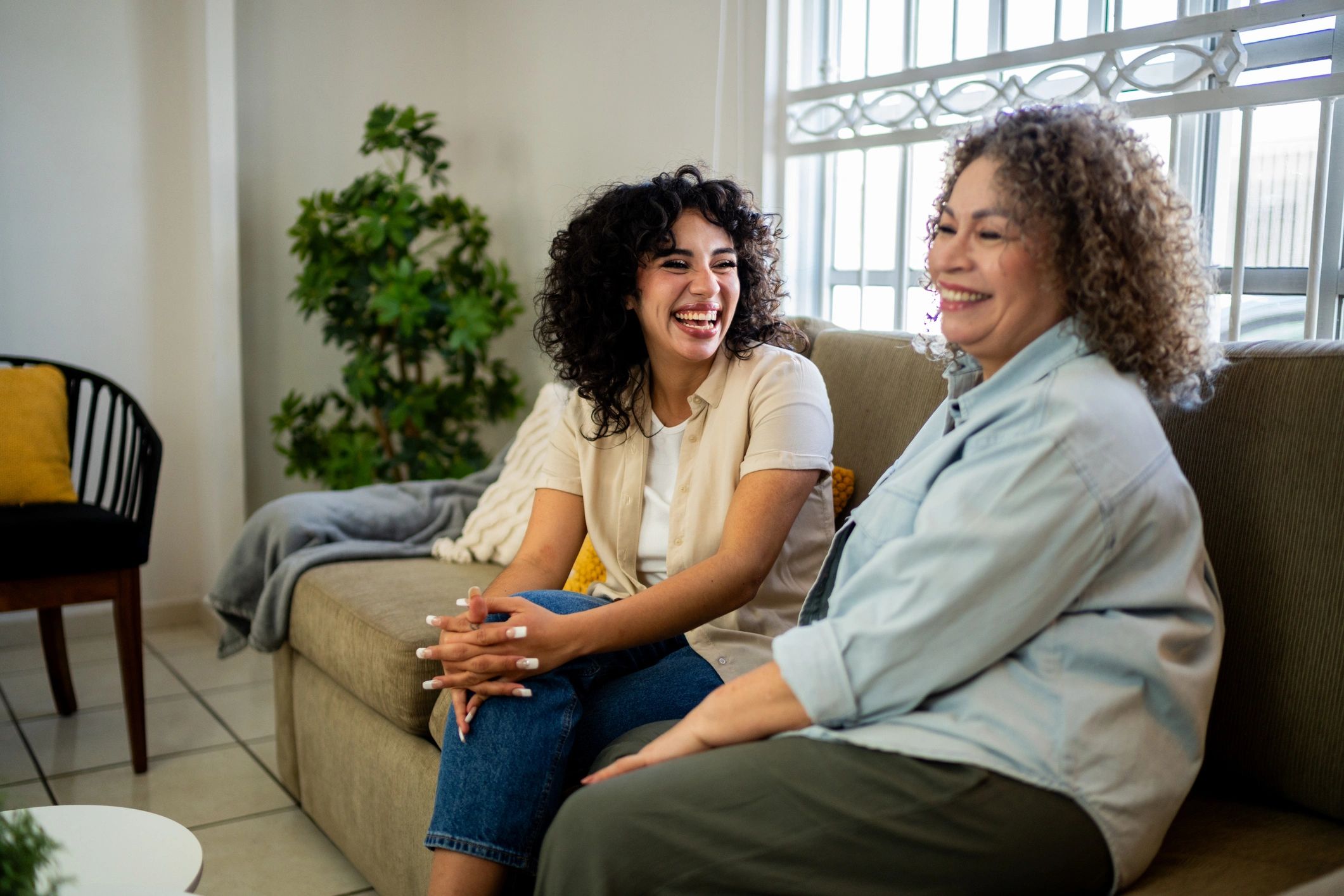 Senior mother and daughter talking at home